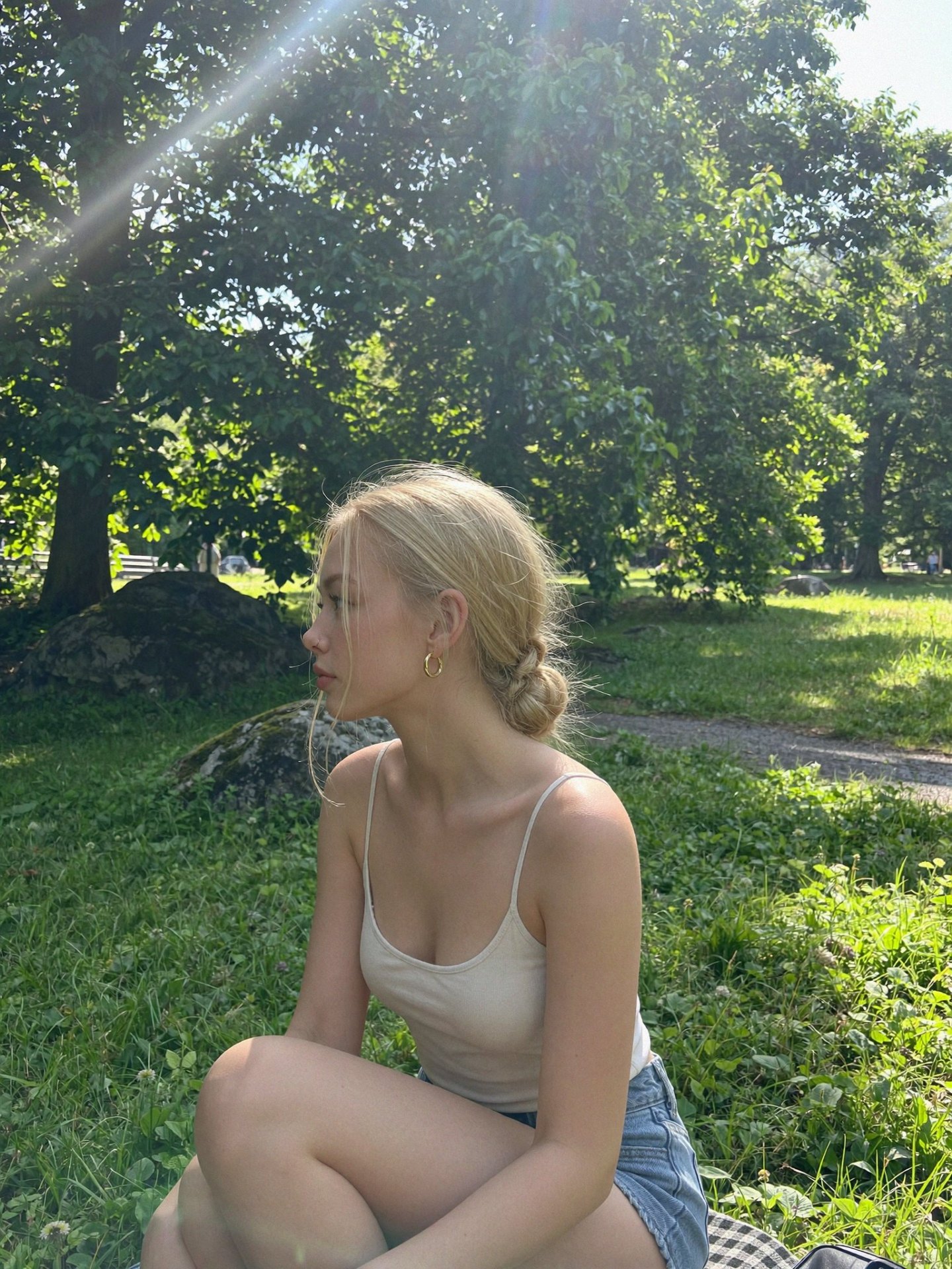 AI influencer sitting in a sunlit park